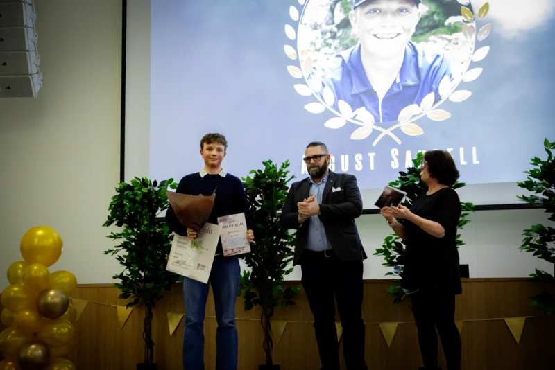 August Sandell tar emot pris för Årets idrottstalang från livsmiljönämndens ordförande Peter Johansson och Ulrika Börjesson från Hörby Kulturhus.