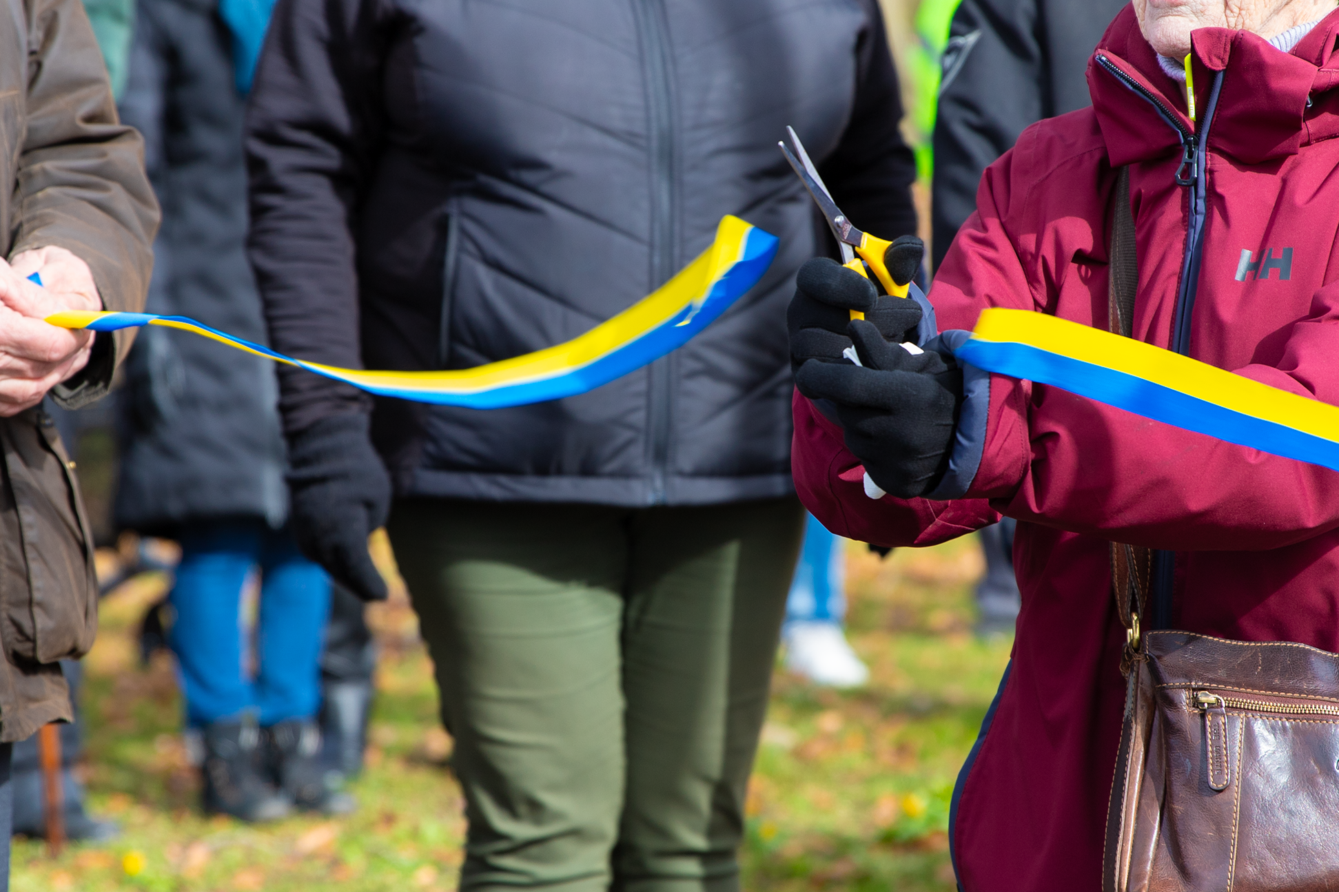 En kvinna klipper ett band med en sax