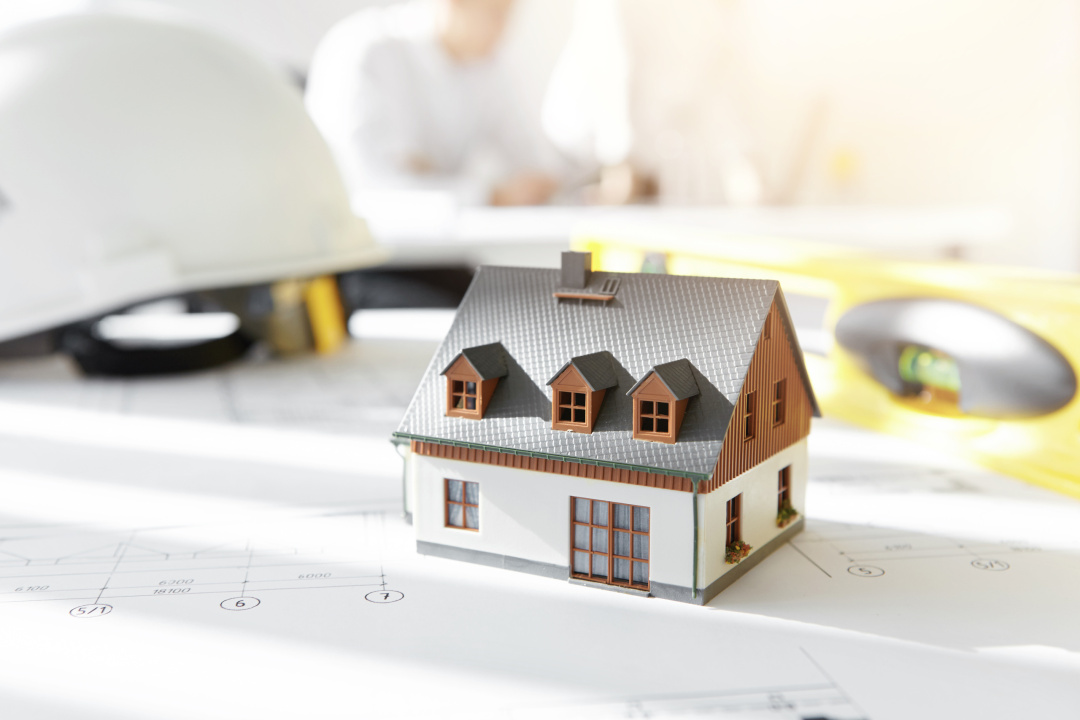 modellhus i miniatyr ovanpå en ritning