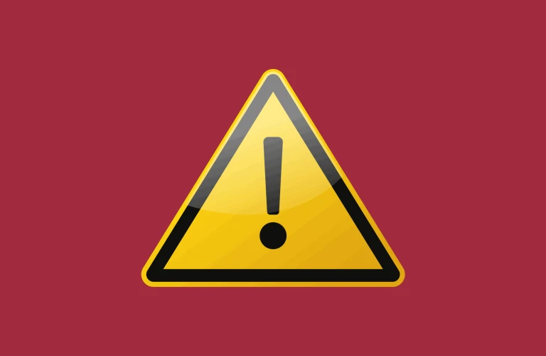 En gul varningstriangel med ett svart utropstecken på en röd bakgrund